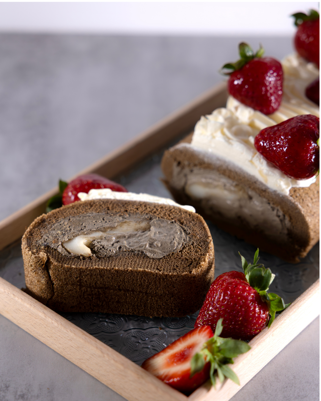 Taiwanese Tieguanyin Tea roll cake with moch, velvety tieguanyin cream, rich salted cheese foam and fresh strawberries. Crafted by Okaeri Bakery in London