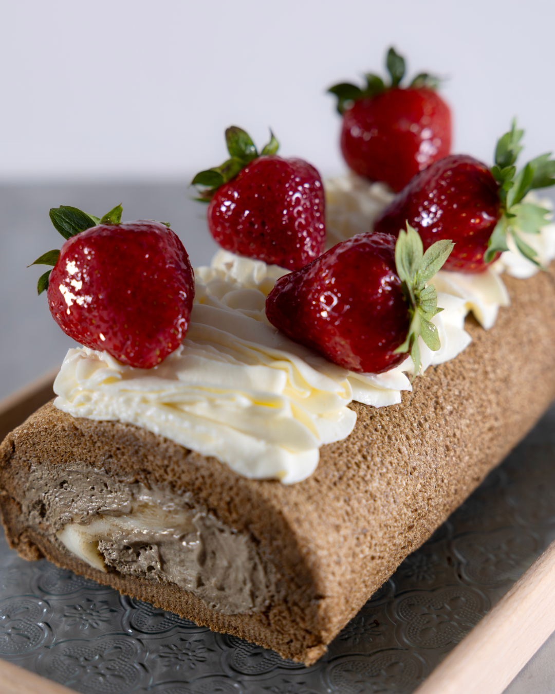 Taiwanese Tieguanyin Tea roll cake with moch, velvety tieguanyin cream, rich salted cheese foam and fresh strawberries. Crafted by Okaeri Bakery in London