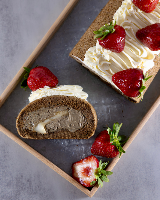 Taiwanese Tieguanyin Tea roll cake with moch, velvety tieguanyin cream, rich salted cheese foam and fresh strawberries. Crafted by Okaeri Bakery in London 